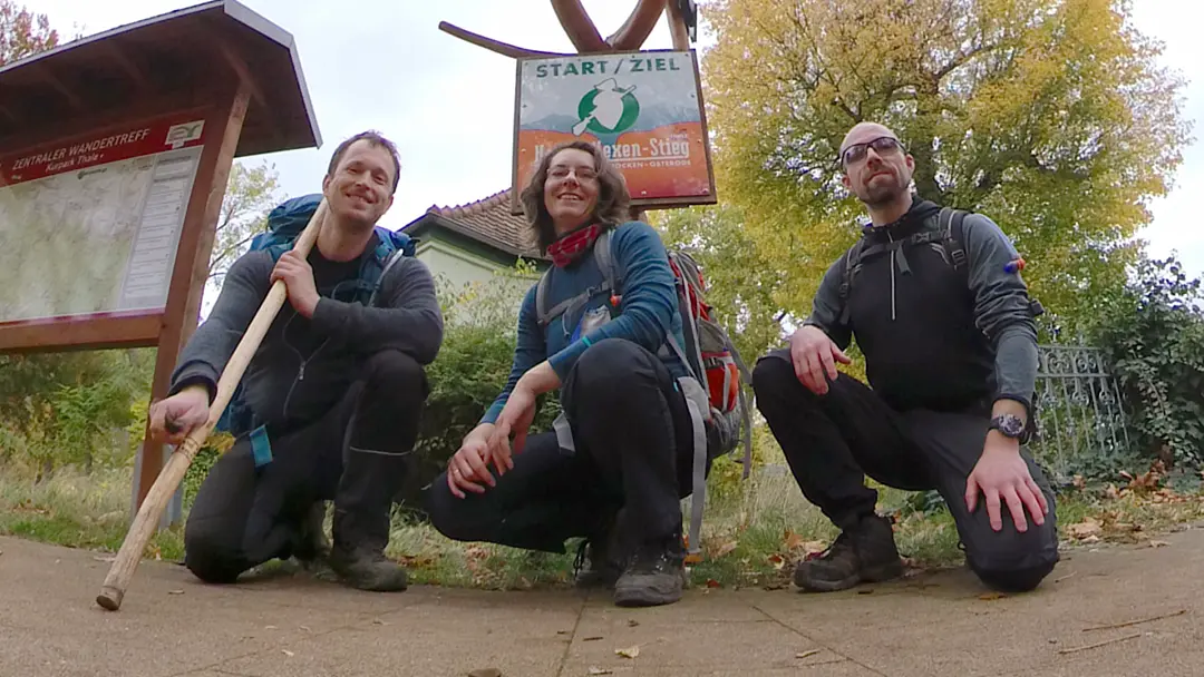 Manu, Daniel, and Markus in front of the sign indicating the end of the Harzer Hexenstieg in Thale