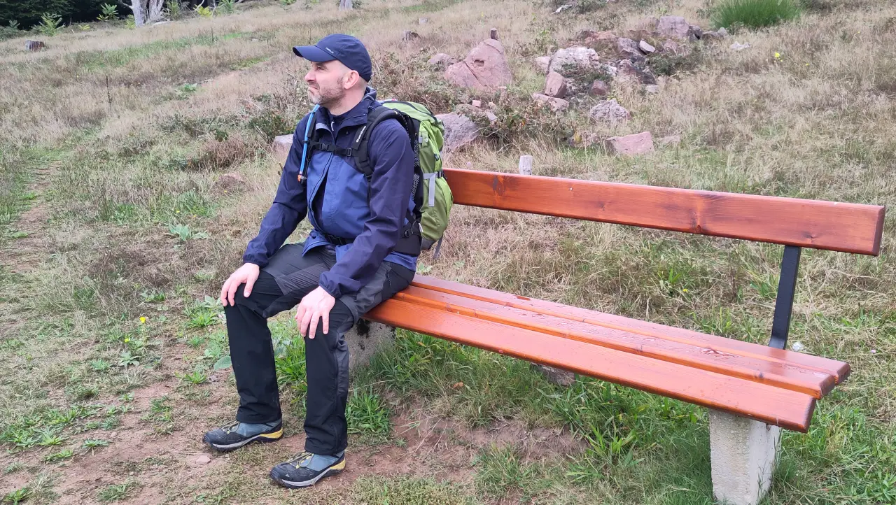 Marcus sitting on a bench with a pained expression, clearly not enjoying the view