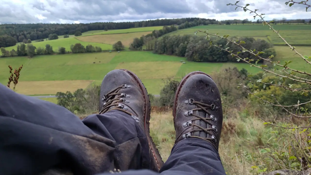 Close-up of my hiking boots with a wide view across the valley from the Beilstein ruins in the background
