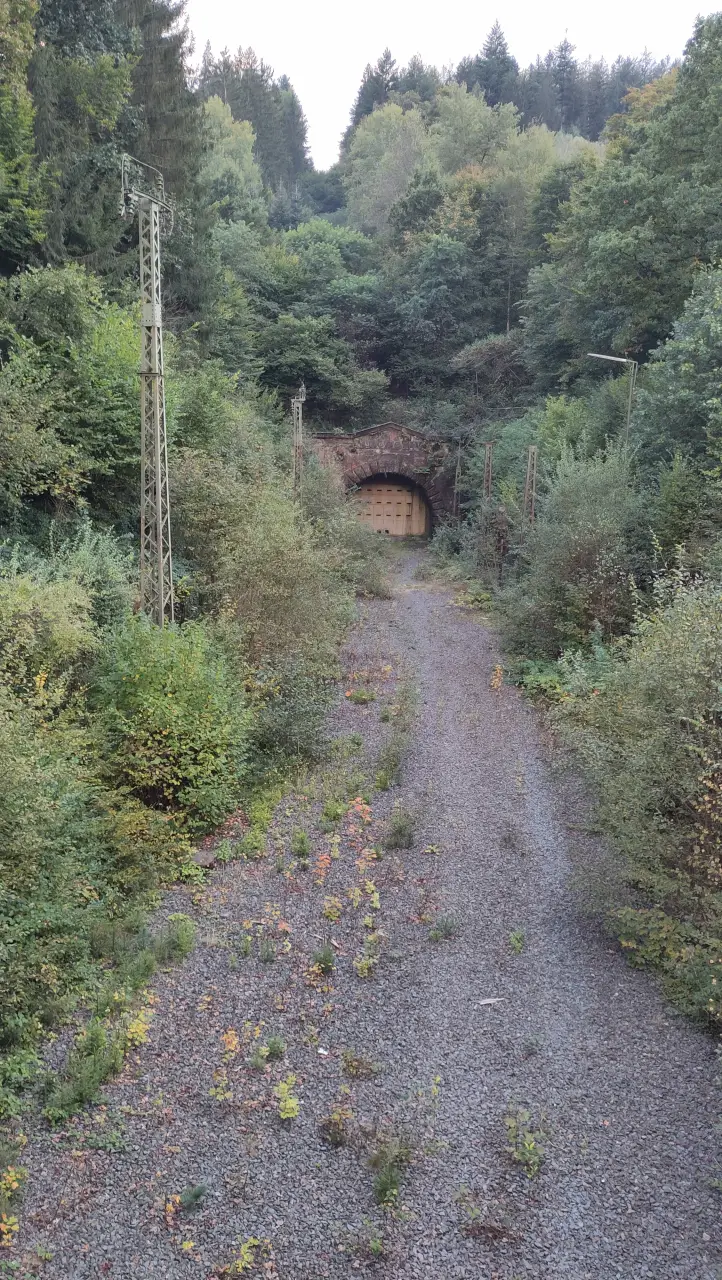 A sealed tunnel portal with a former railway track
