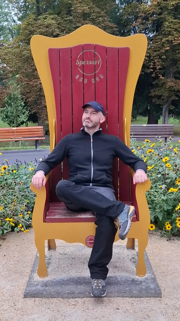 Marcus sitting on a large throne in the spa park